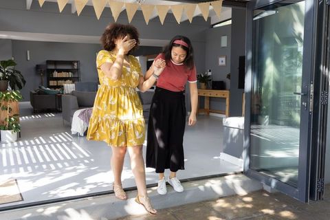Diverse Woman Friends Walking Through Open Sliding Door