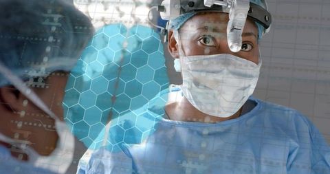 Surgeon performing surgery with headlight and mask, blue gown and digital hex overlay