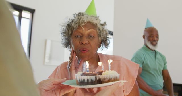 Happy senior diverse people at birthday party with cake at retirement home - Download Free Stock Photos Pikwizard.com