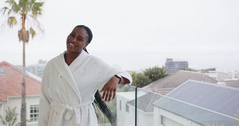 African american woman enjoying view in elegant waterfront setting