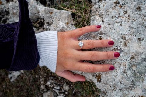 Close-up of Hand With Engagement Ring on Rocky Surface