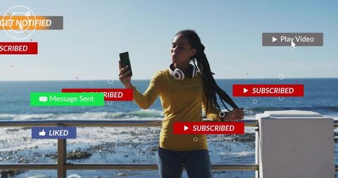 Woman in Casual Holding Smartphone on Coastal Promenade with Digital UI