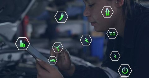 Female mechanic inspecting tablet with augmented reality vehicle diagnostics in garage