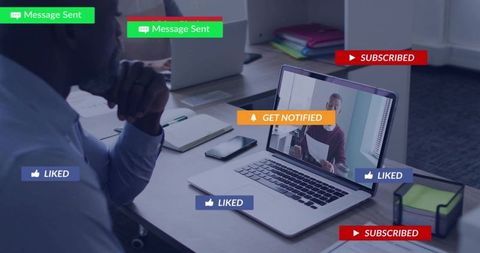 Mature businessman watching video conference on laptop with social likes and notification badges