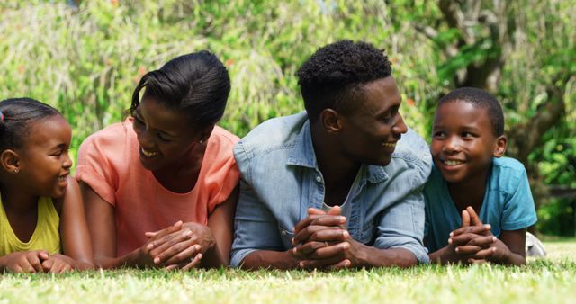 Happy Family Lying on Grass Enjoying Time Together - Download Free Stock Images Pikwizard.com