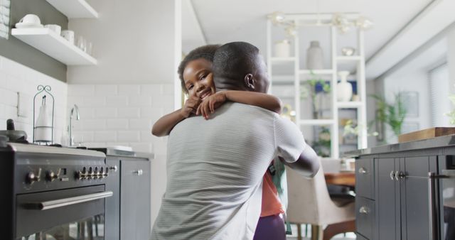 Loving Father Embracing His Daughter in Modern Kitchen - Download Free Stock Images Pikwizard.com