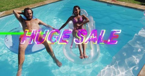 Couple Relaxing on Inflatable Floats in Backyard Pool Holding Hands with Neon Sale Text