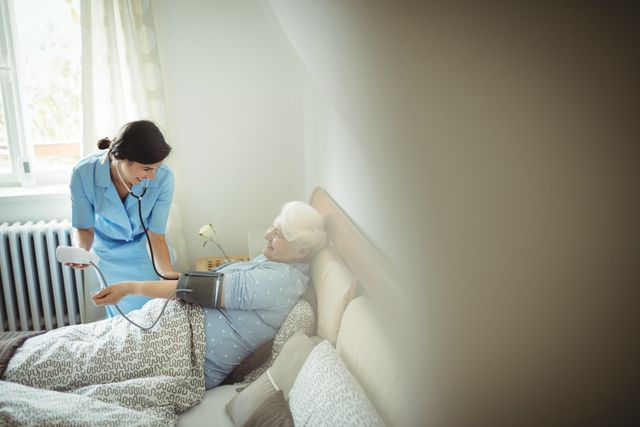 Nurse Checking Blood Pressure of Senior Woman at Home - Download Free Stock Photos Pikwizard.com