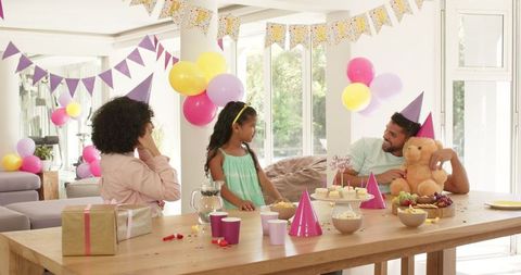 Joyful Family Celebrating Birthday with Daughter at Decorated Table