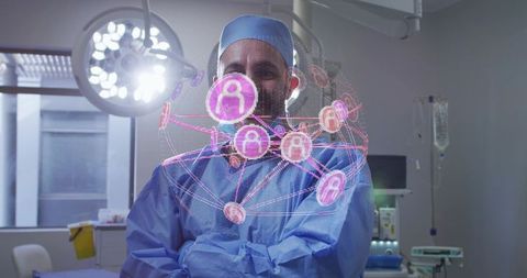 Male surgeon standing with arms crossed displaying holographic healthcare network