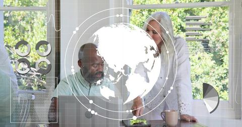 Senior couple collaborating on digital analytics at home with futuristic HUD globe overlay