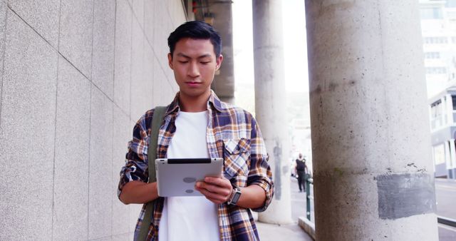 Young Man Using Digital Tablet on City Street - Download Free Stock Images Pikwizard.com