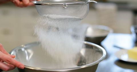 Sifting flour in a kitchen for perfect baking