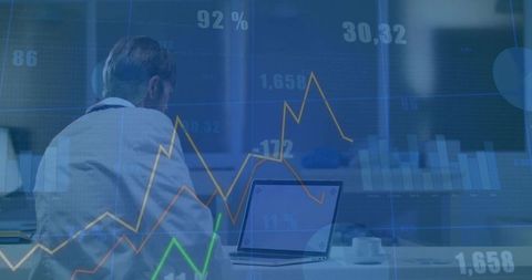 Business Professional Reviewing Financial Charts in Office