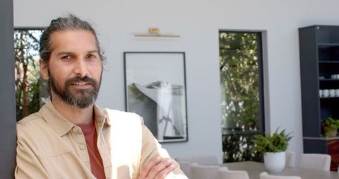 Confident Man Relaxing Indoors in Casual Wear