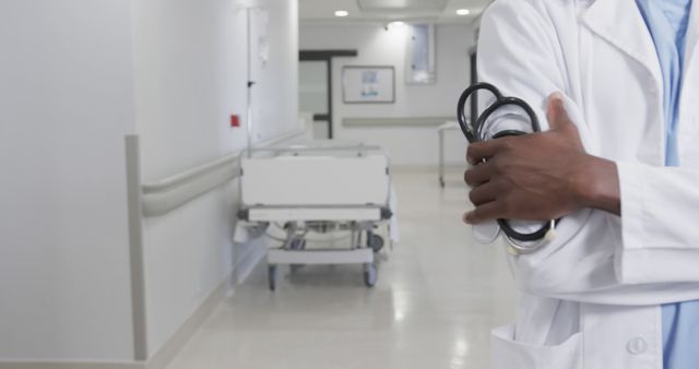 Doctor Holding Stethoscope in Modern Hospital Hallway - Download Free Stock Images Pikwizard.com