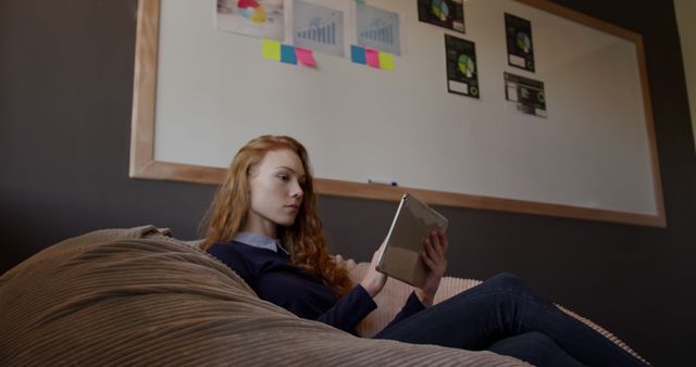 Businesswoman Engaged with Tablet in Modern Office Environment - Download Free Stock Images Pikwizard.com