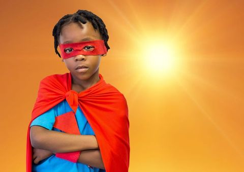 Child superhero expressing empowerment and confidence with sunburst