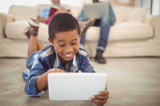 Happy Boy Using Digital Tablet in Living Room - Download Free Stock Photos Pikwizard.com