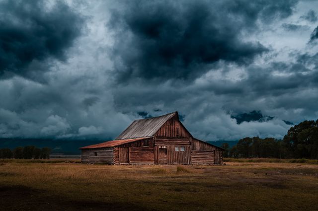Old Wooden Barn in Countryside Under Dark Stormy Sky - Download Free Stock Photos Pikwizard.com