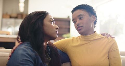 Supportive Friendship Between Diverse Women on Indoor Sofa