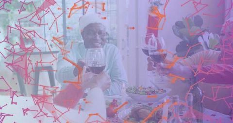 Seniors toasting holiday dinner with wine glasses and santa hat, festive home gathering
