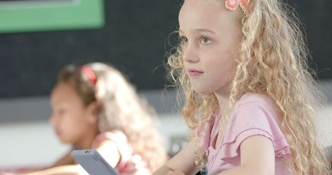 Girl using tablet in classroom for digital learning and education
