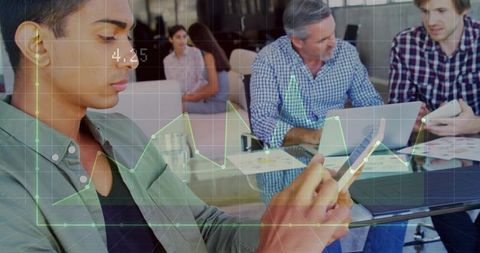 Checking smartphone while team reviewing charts and laptop data during meeting