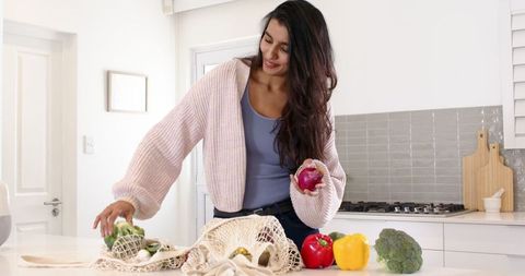 Woman embracing eco-friendly lifestyle in modern kitchen