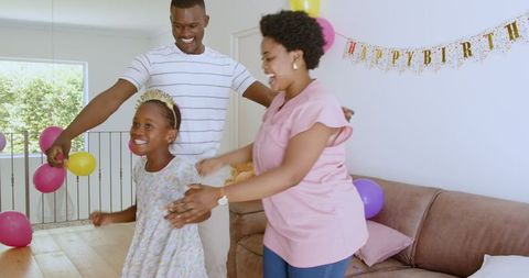 Happy African American Family Celebrating Birthday Together at Home