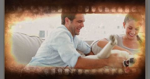 Happy Couple Enjoying Quality Time with Playful Dog at Home