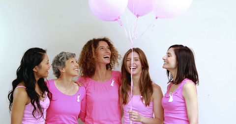 Happy Women Celebrating in Pink for Breast Cancer Awareness