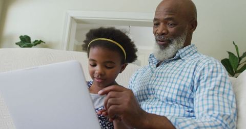 Grandfather and Granddaughter Bonding Over Tablet