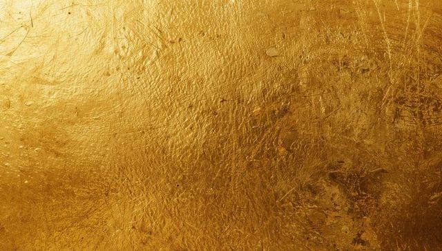 Textured golden metallic surface with reflective sheen