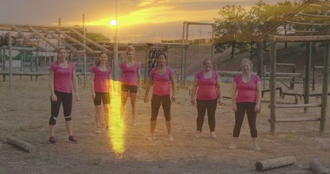 Diverse Group of Women Exercising at Obstacle Course at Sunset