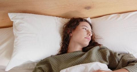 Young woman relaxing in contemporary bedroom setting