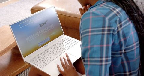 Woman in Plaid Shirt Booking Travel Online on White Laptop - Download Free Stock Images Pikwizard.com