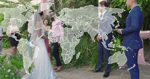 Bride and groom exchanging vows in garden under pink drapery with world map overlay