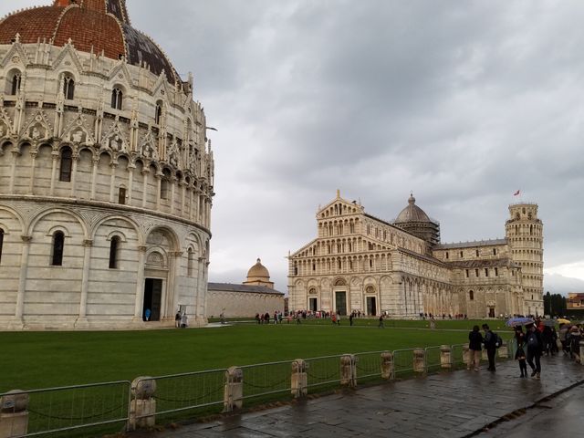 Tourists visiting historic Pisa landmarks on cloudy day - Download Free Stock Images Pikwizard.com