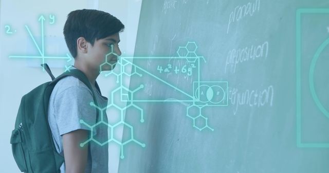 Image of dna strand diagrams and mathematical equations over biracial schoolboy at chalkboard. Education, childhood, school and learning concept digitally generated image.