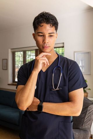 Asian healthcare professional checking smartwatch indoors