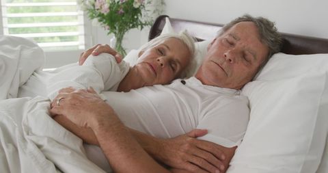 Senior Couple Relaxing and Sleeping Peacefully in Bright Bedroom