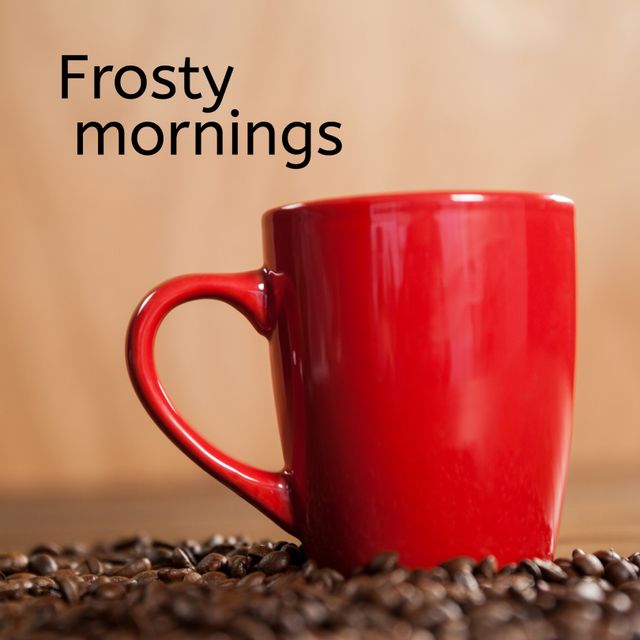 Red coffee mug surrounded by coffee beans evokes a cozy start to a frosty winter morning, perfect for seasonal promotions or holiday-themed backdrops. Ideal for conveying warmth and celebration during the winter season.