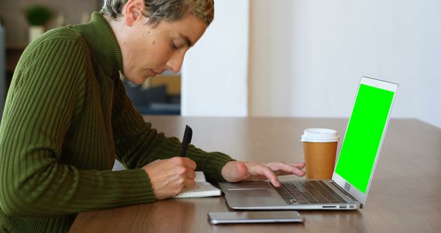 Person Working on Laptop Taking Notes in Modern Office - Download Free Stock Images Pikwizard.com