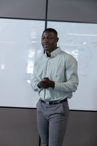 Confident Professional Presenting in Modern Conference Room