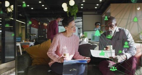 Colleagues reviewing documents with ar overlay in modern open-plan office for teamwork