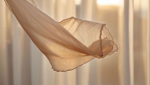Sheer Beige Fabric Floating in Warm Backlight, Translucent Drapery Abstract