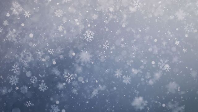 Falling snowflakes drifting through soft bokeh winter sky frosty gradient light particles