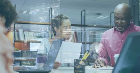 Diverse business team collaborating on data analytics with digital dashboards and documents