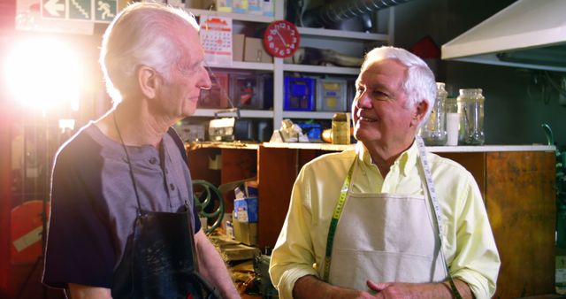 Senior Craftsmen Conversing in Workshop, Warm Lighting - Download Free Stock Images Pikwizard.com